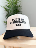 PUT IT ON MY HUSBAND'S TAB Letter Trucker Hat